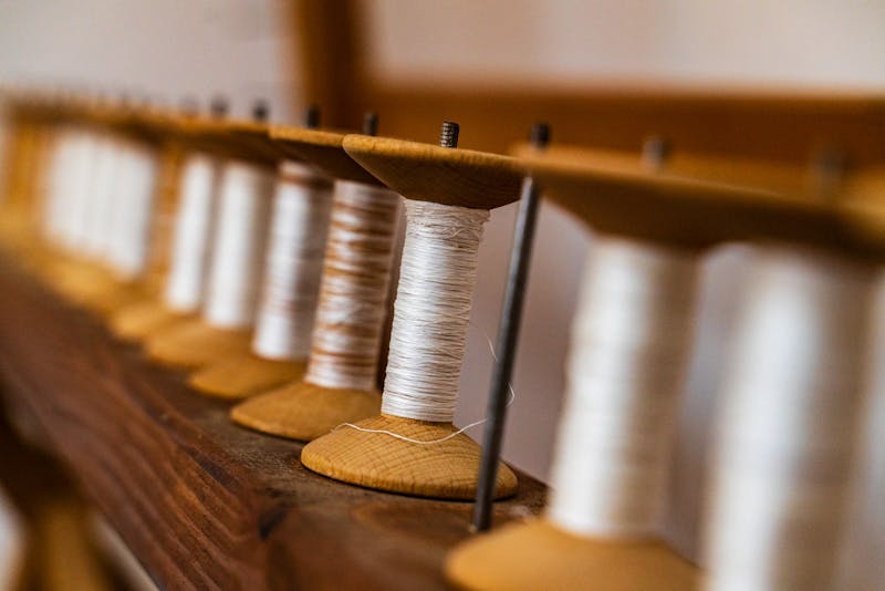 Vintage wooden spools with fine thread